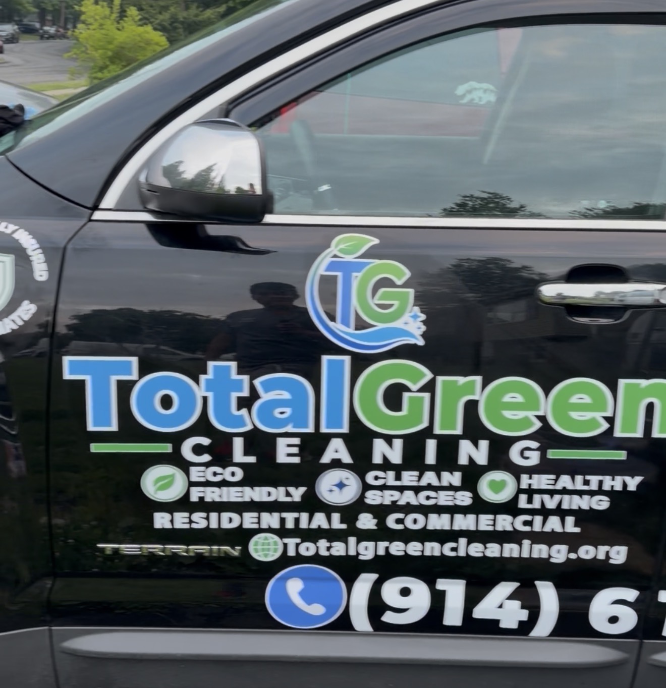 Black and green lettering on a white contractor truck door